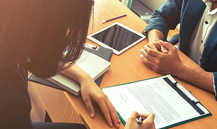 Job candidate signing offer letter