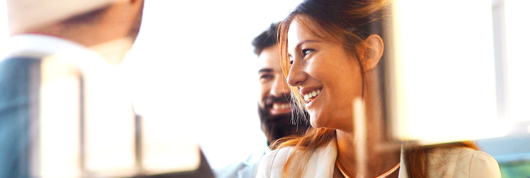 2 iCIMS employees smiling with a company partner