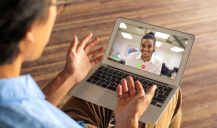 Two remote employees talking via video conferencing software