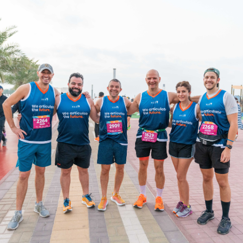 Employees pose in KEO branded running clothes