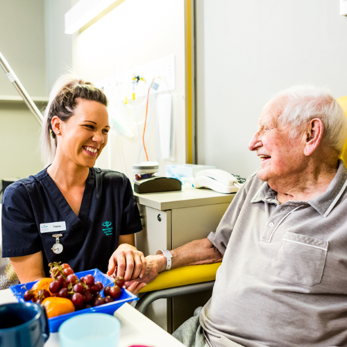 Mercy Health nurse sits with a patient