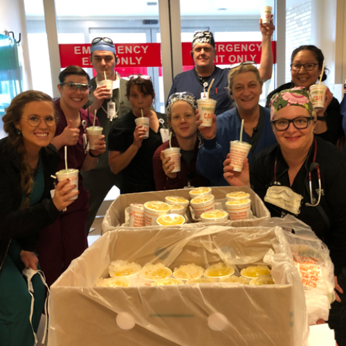Healthcare team at Norman Regional Health poses with a delivery of food