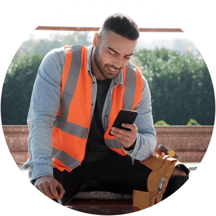Rydon construction worker and satisfied iCIMS' customer looking at his mobile phone and smiling