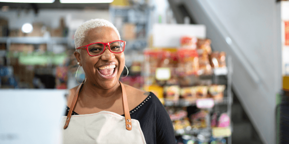 Woman laughs while working a register