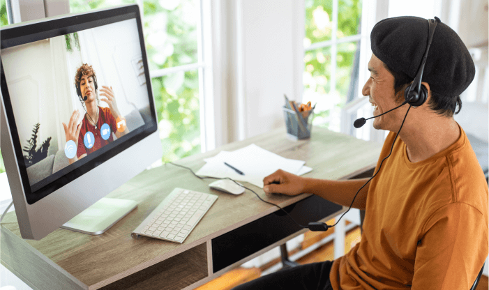 french man with headset on zoom call from home office