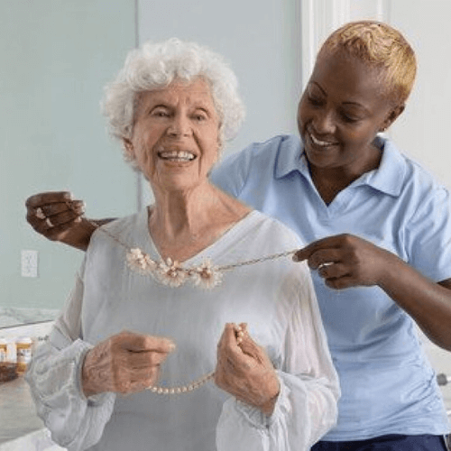 TheKey caregiver puts necklace on client